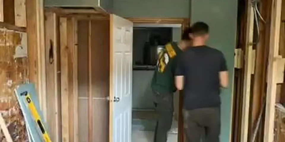 Bathroom remodel hallway with walls opened to framing for Plumbing Service in the Lakewood Mutuals, Lakewood CA