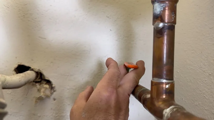 Copper pipe access opening at a wall repair for What Type of Pipes Are in Most Lakewood, CA Homes?