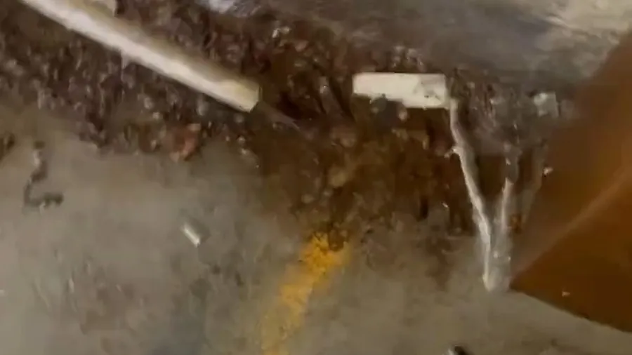 Corroded pipe exposed in a small slab opening for Plumber in Bellflower, CA