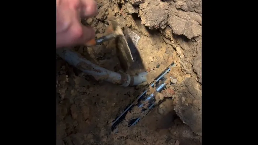 Damaged sewer pipe exposed in muddy soil for Plumbing Service in the Lakewood Mall Area, Lakewood CA