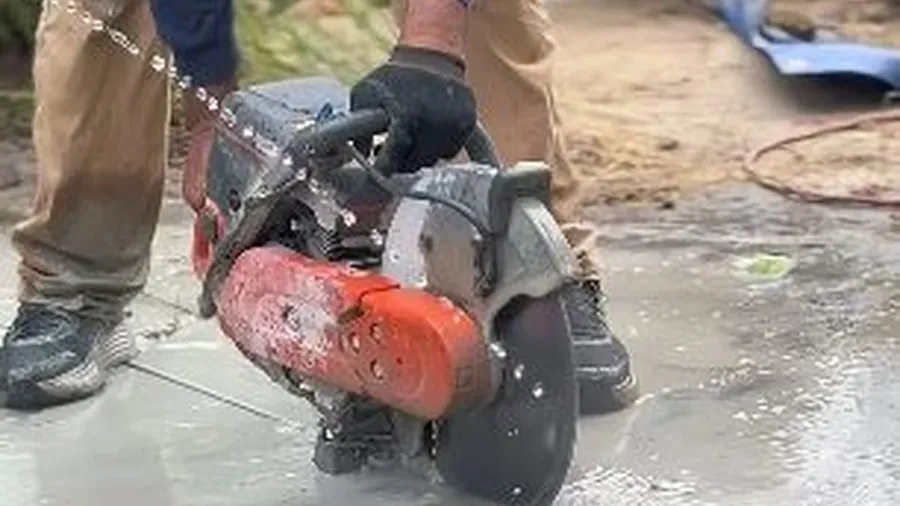 Hydro jetting nozzle clearing concrete surface near a drain line for Drain Cleaning & Unclogging in Lakewood, CA