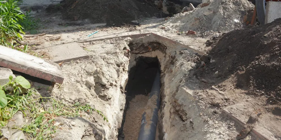 Long open trench prepared for sewer pipe replacement for Sewer Line Replacement in Lakewood, CA