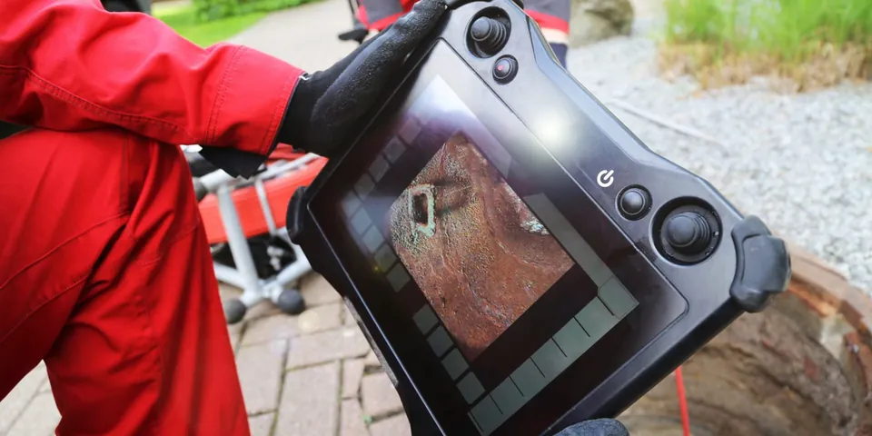 Technician holding a pool leak detection camera monitor for Pool Leak Detection & Repair in Lakewood, CA