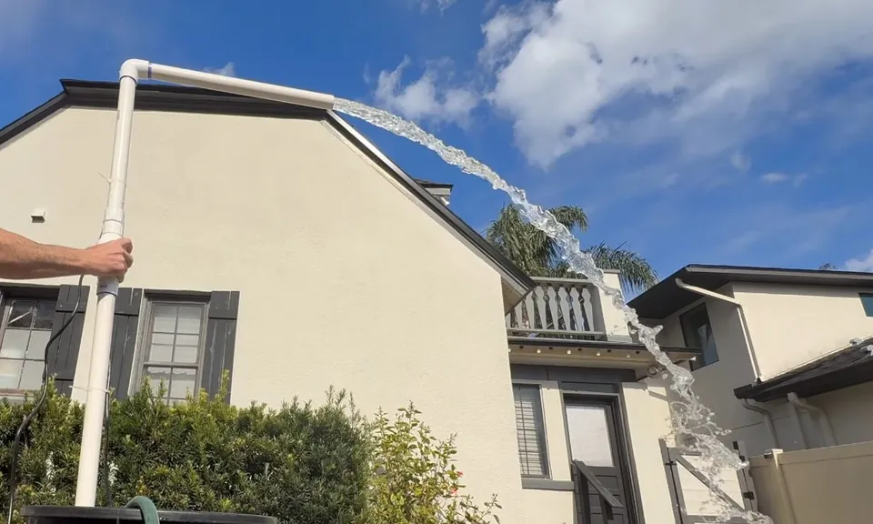Two-story residential home exterior with rooftop solar panels for Plumbing Services in Lakewood, CA