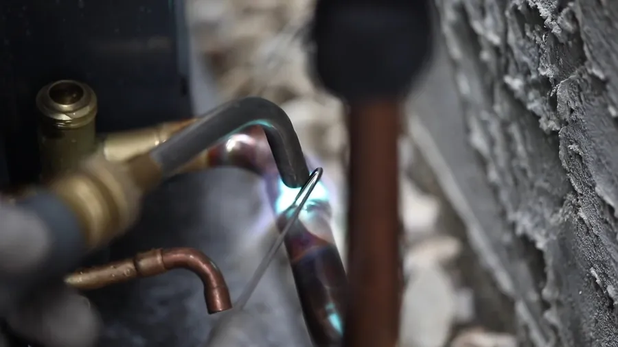 Plumber working on a water heater control connection for Water Heater Repair in Lakewood, CA